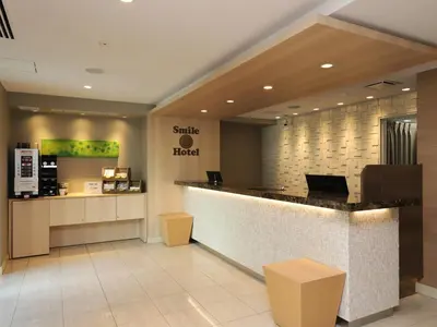 a lobby of a silla hotel with a counter at Smile Hotel Shinagawa Sengakuji Ekimae in Tokyo