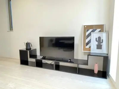 a black entertainment center with a flat screen tv at Senjyu House in Tokyo