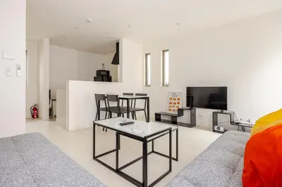 a living room with a couch and a table at Senjyu House in Tokyo