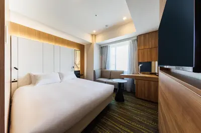 a hotel room with a bed and a tv at JR-East Hotel Mets Shibuya in Tokyo