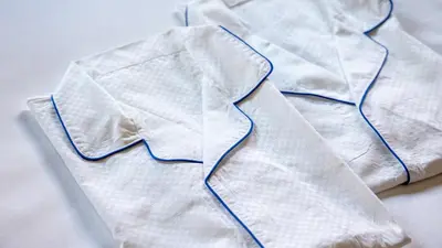 a pair of white napkins sitting on a bed at JR-East Hotel Mets Shibuya in Tokyo