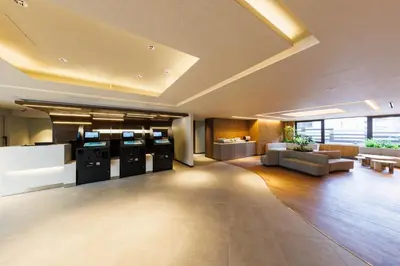 a large room with a lobby with a couch and tables at JR-East Hotel Mets Shibuya in Tokyo