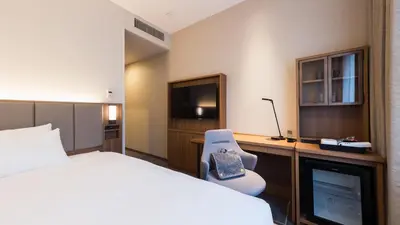 a hotel room with a bed and a television at JR-East Hotel Mets Mejiro in Tokyo