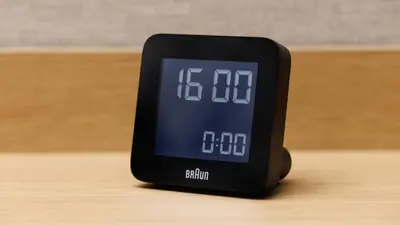 an alarm clock sitting on top of a wooden table at JR East Hotel Mets Premier Akihabara in Tokyo