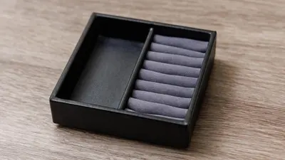 a black box filled with purple towels on a wooden table at JR East Hotel Mets Premier Akihabara in Tokyo
