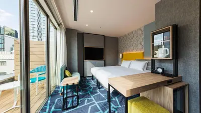 a hotel room with a bed and a desk at JR East Hotel Mets Premier Akihabara in Tokyo