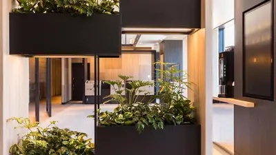 an office with plants in pots in the hallway at JR East Hotel Mets Premier Gotanda in Tokyo