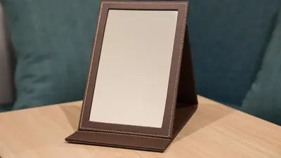 a mirror in a brown frame on a table at JR East Hotel Mets Premier Tokyo Bay Shinkiba in Tokyo