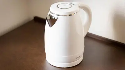 a white electric kettle sitting on a table at JR-East Hotel Mets Akabane in Tokyo