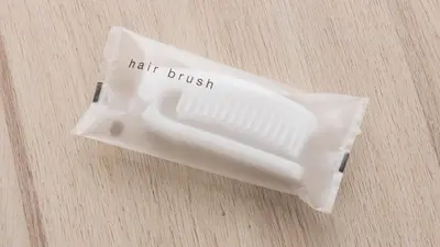 a white hair brush sitting on top of a table at JR-East Hotel Mets Akabane in Tokyo