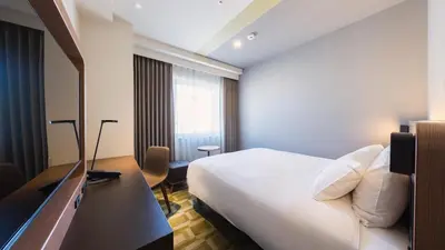 a hotel room with a bed and a television at JR-East Hotel Mets Akabane in Tokyo