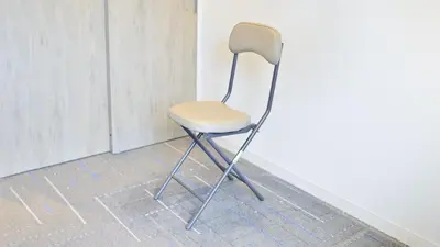 a white chair sitting next to a wall at JR-East Hotel Mets Omori in Tokyo