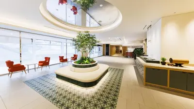 a living room with a table with a plant in it at JR-East Hotel Mets Omori in Tokyo