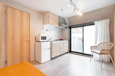 a small kitchen with a white refrigerator and a window at Designed apart ment Yamanote Line Shin-Okubo Sta 3 min walk in Tokyo