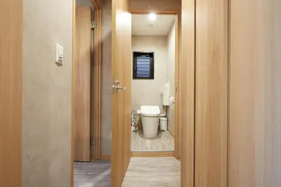 a bathroom with a toilet and a door to a room at Designed apart ment Yamanote Line Shin-Okubo Sta 3 min walk in Tokyo