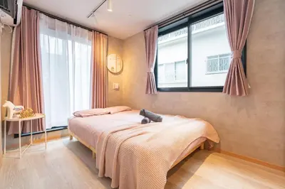 a bedroom with a bed with a teddy bear on it at Designed apart ment Yamanote Line Shin-Okubo Sta 3 min walk in Tokyo