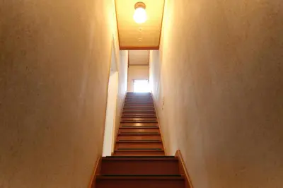 a hallway with stairs with a light at the top at Minami-Shinagawa House by Tranova in Tokyo