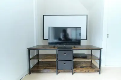 a console table with a television on top of it at Minami-Shinagawa House by Tranova in Tokyo