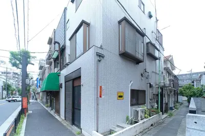 a white building on the side of a street at Minami-Shinagawa House by Tranova in Tokyo