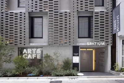 an entrance to an art and cafe on a building at Spatium Ginza Pony in Tokyo