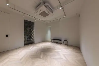 an empty room with a table and a bench in it at Spatium Ginza Pony in Tokyo