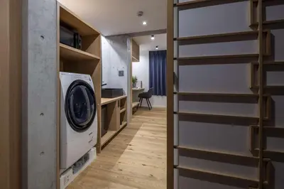 a laundry room with a washer and dryer at Spatium Ginza Pony in Tokyo