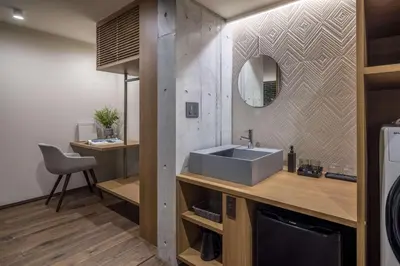 a bathroom with a sink and a mirror at Spatium Ginza Pony in Tokyo