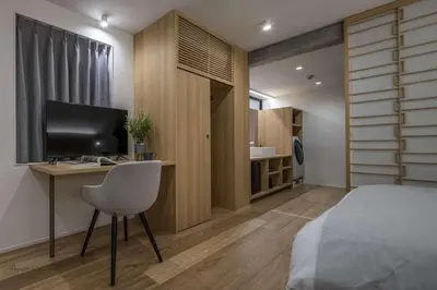 a bedroom with a desk and a bed and a television at Spatium Ginza Pony in Tokyo
