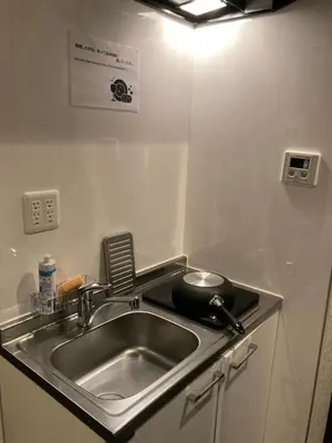 a kitchen with a sink and a counter top at Hostel LodgingToyko Minowa in Tokyo
