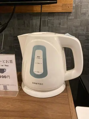 a white electric kettle sitting on top of a table at Hostel LodgingToyko Minowa in Tokyo