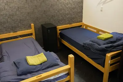 a room with two bunk beds in a room at Hostel LodgingToyko Minowa in Tokyo