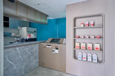 a kitchen with a counter and a refrigerator with milk bottles at fav TOKYO NISHINIPPORI in Tokyo