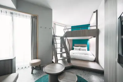 a small bedroom with a bunk bed and a staircase at fav TOKYO NISHINIPPORI in Tokyo
