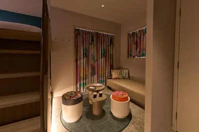 a small room with two beds and two stools at fav TOKYO NISHINIPPORI in Tokyo