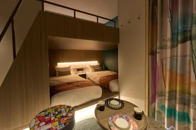 a small bedroom with two beds and a table at fav TOKYO NISHINIPPORI in Tokyo