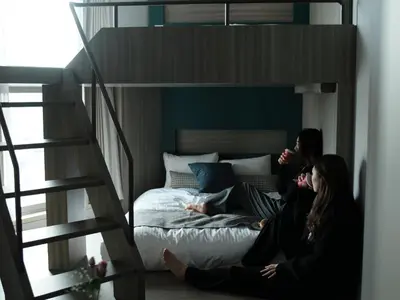 two women sitting on a bed in a loft at fav TOKYO NISHINIPPORI in Tokyo