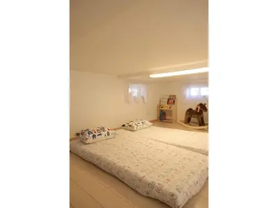 a bedroom with a bed with two pillows on it at Forest House - Vacation STAY 44322v in Tokyo