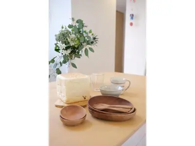 a table with a cutting board with bowls and a cheese at Forest House - Vacation STAY 44322v in Tokyo