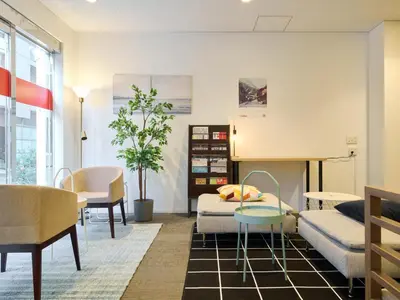 a living room with a bed and a table at Tabist Ginza in Tokyo
