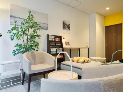 a waiting room with two chairs and a couch at Tabist Ginza in Tokyo
