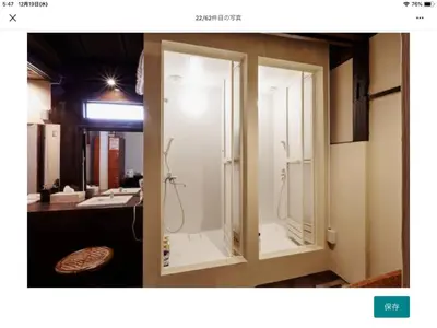 a bathroom with two glass doors and a sink at Asahiyuplus in Tokyo