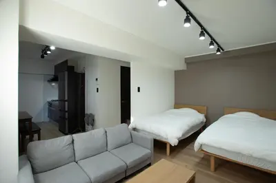 a living room with two beds and a couch at LUCKY house43 in Tokyo