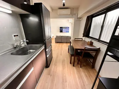 a kitchen with a sink and a table in a room at LUCKY house43 in Tokyo