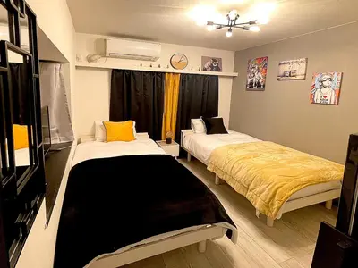 a bedroom with two beds and a window at tani house in Tokyo