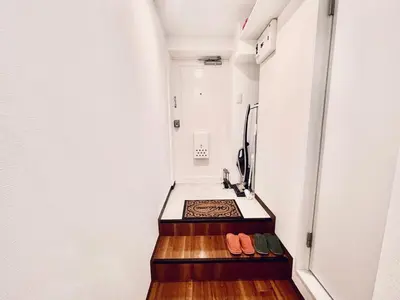 a narrow hallway with a sink in a room at tani house in Tokyo