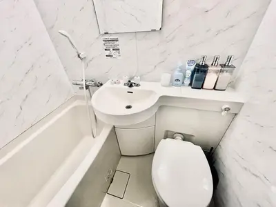 a white bathroom with a sink and a toilet at tani house in Tokyo