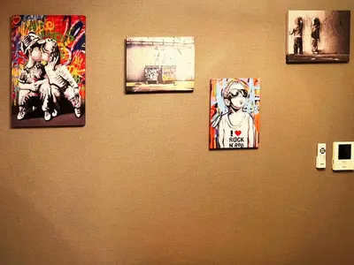 a group of pictures on a wall at tani house in Tokyo