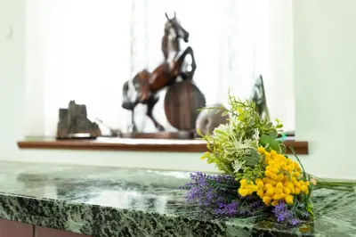 a bouquet of flowers on a counter with a statue at \u54c1\u5ddd\u30a6\u30a3\u30b9\u30c6\u30ea\u30a2\u30ec\u30b8\u30c7\u30f3\u30b9 - Shinagawa Wisteria Residence in Tokyo
