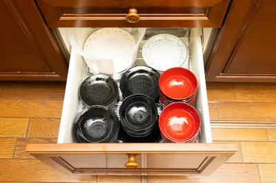 a drawer filled with plates and other dishes at \u54c1\u5ddd\u30a6\u30a3\u30b9\u30c6\u30ea\u30a2\u30ec\u30b8\u30c7\u30f3\u30b9 - Shinagawa Wisteria Residence in Tokyo