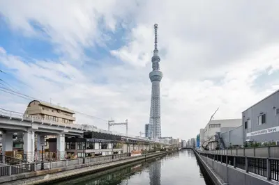 a view of a river with a tower in the background at \u30d1\u30fc\u30af\u30a2\u30af\u30b7\u30b9\u672c\u6240\u543e\u59bb\u6a4b\u30b5\u30a6\u30b9\u30ec\u30b8\u30c7\u30f3\u30b9 in Tokyo